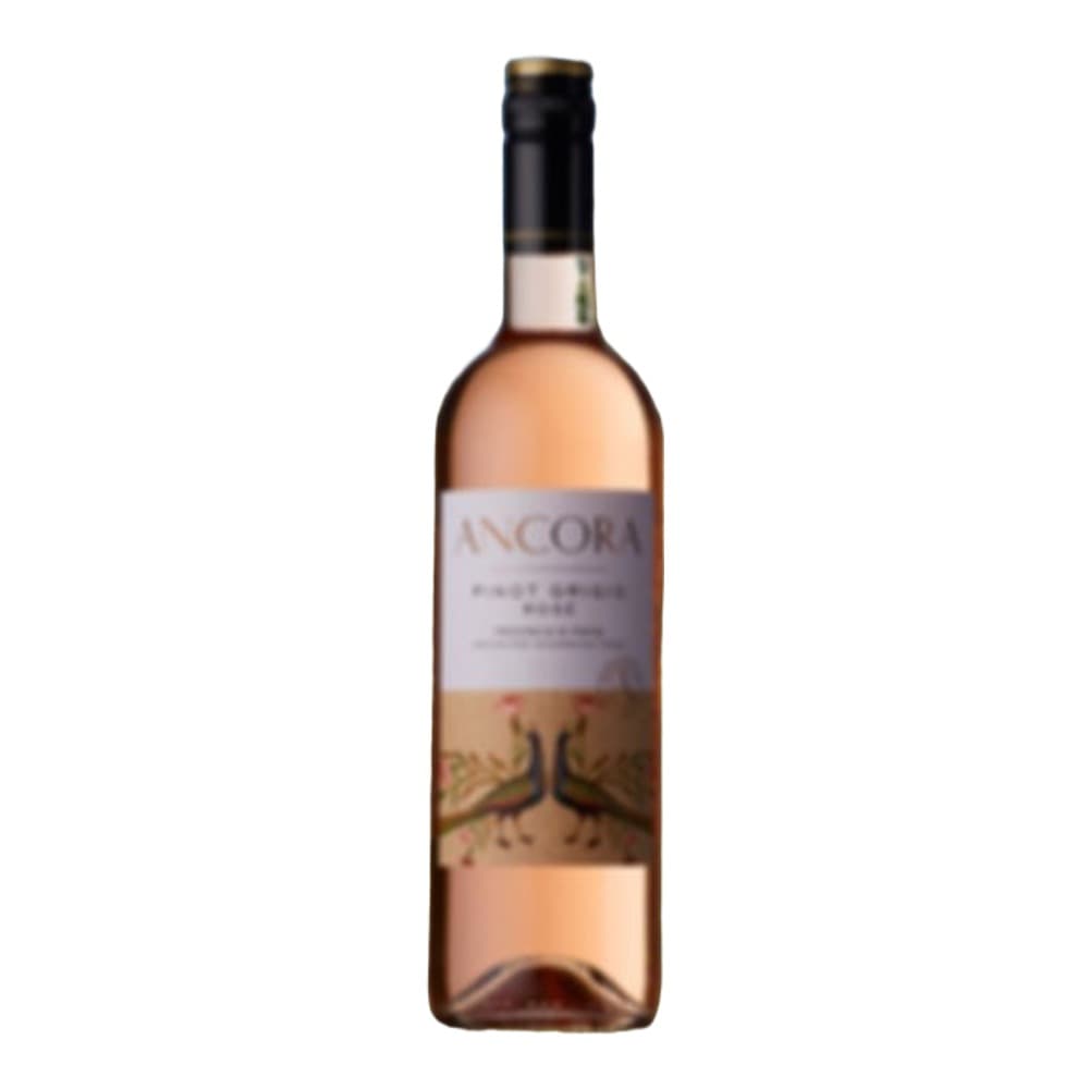 A bottle of Ancora rosé wine displayed outdoors with vineyard landscape and blue sky in the background