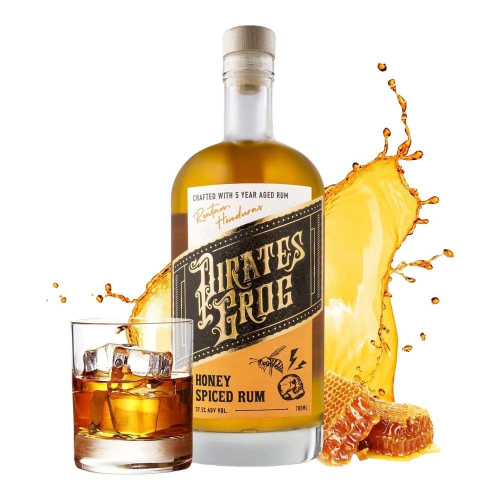 A bottle of Pirate's Grug honey spiced rum positioned next to a glass of rum with ice and a splash of liquid, accompanied by honeycomb and a dramatic liquid splash effect against a white background.