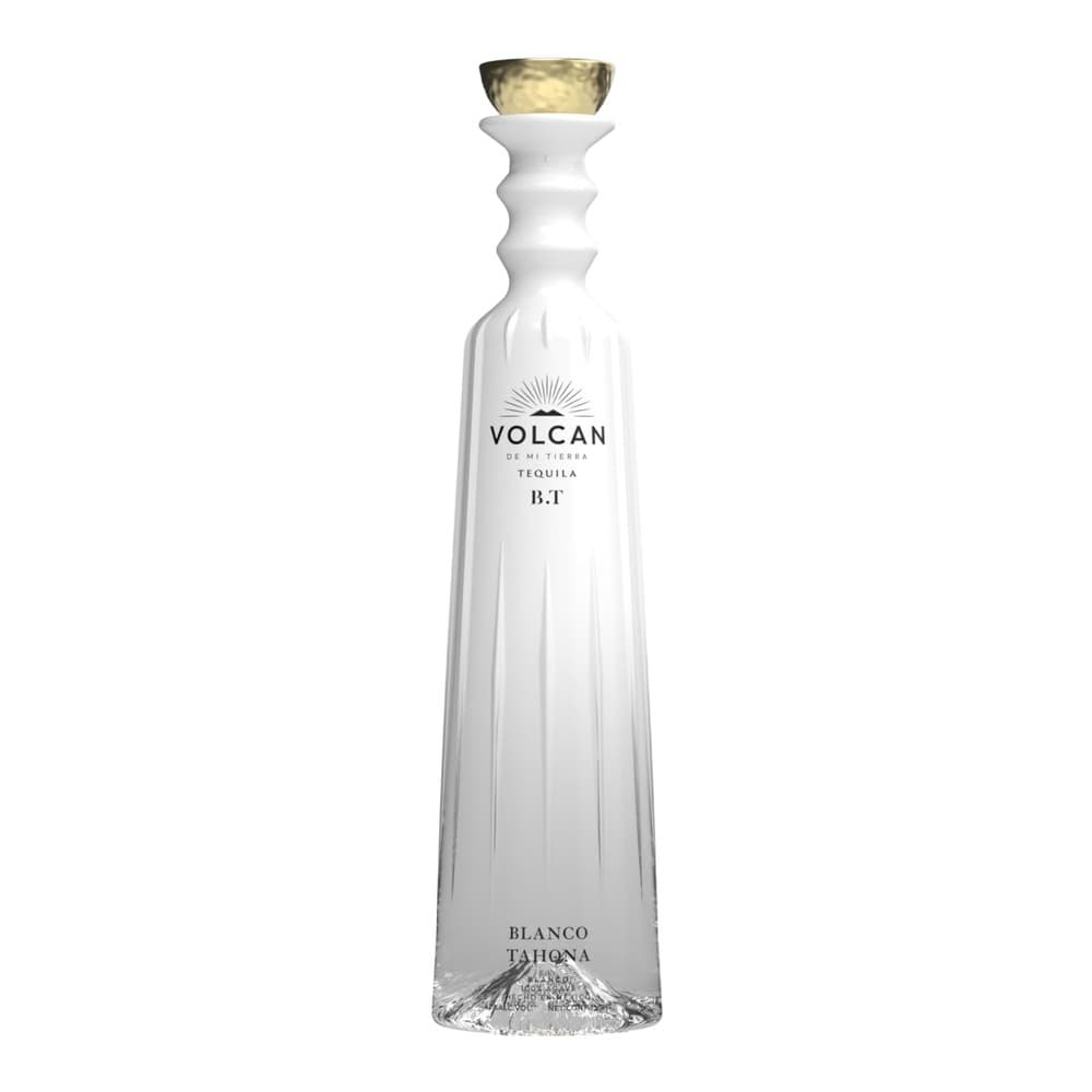 A white Volcan tequila bottle with a gold cork top, displayed on a plain white background. The bottle features the Volcan branding and indicates it is a Blanco Tequila.