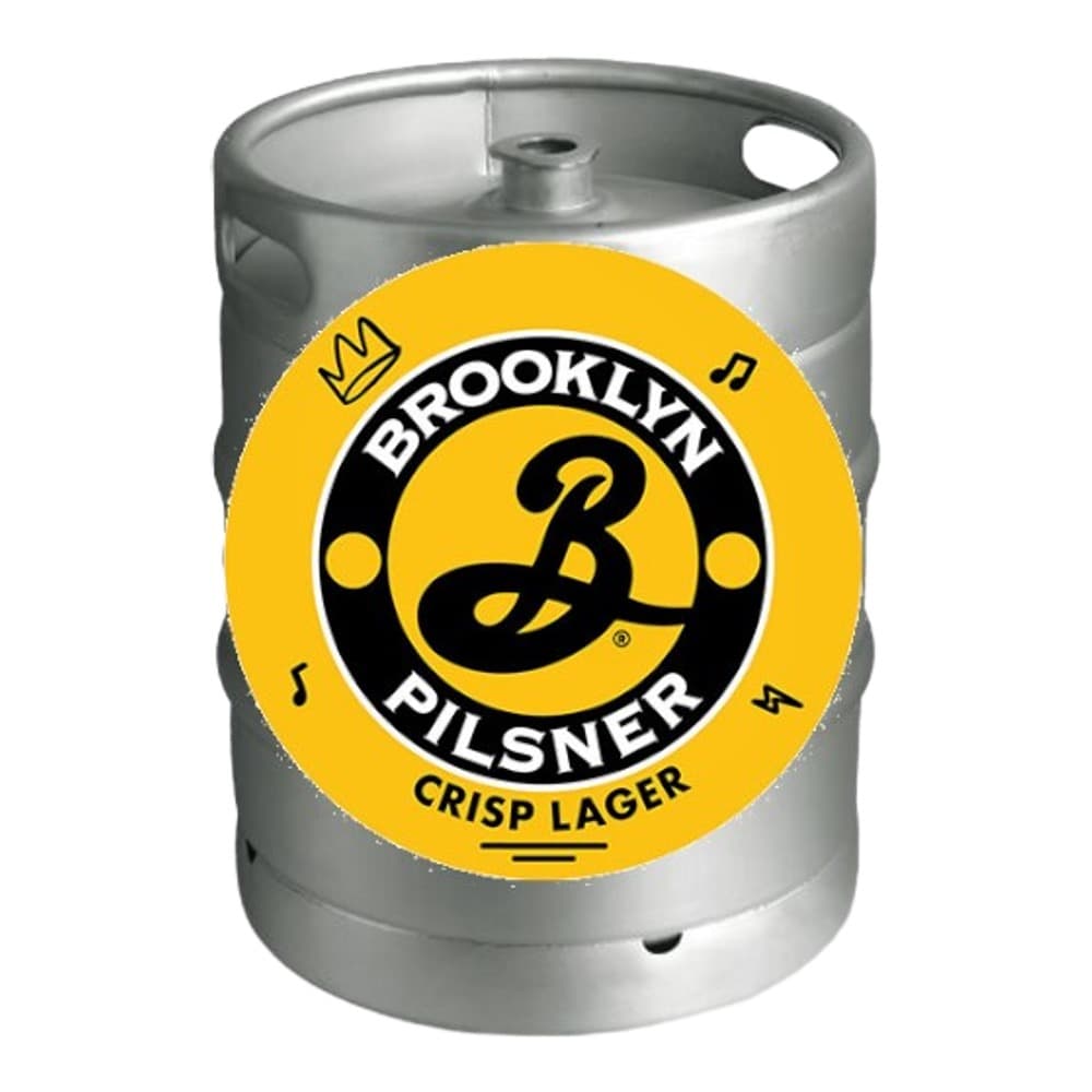 A stainless steel keg with a yellow circular Brooklyn Pilsner label featuring the brand logo and 'Crisp Lager' text.