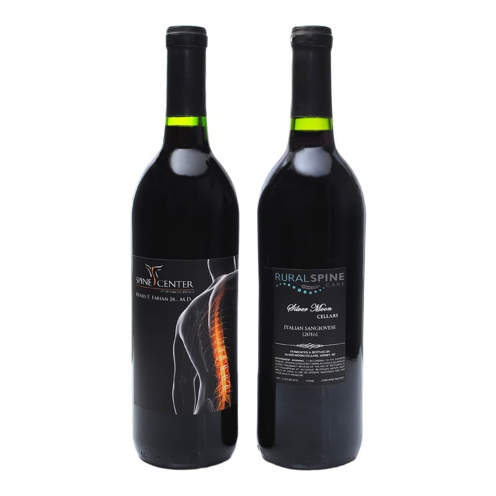 Two dark wine bottles with black labels featuring Spine Center and Rural Spine Care branding, displayed against a plain white background.