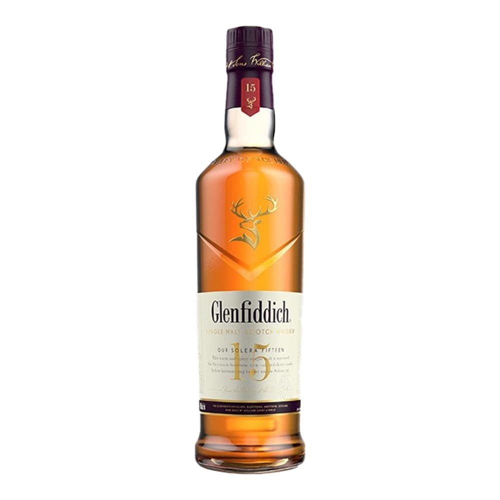 A bottle of Glenfiddich 15 year old single malt scotch whisky with a dark purple cap and cream label featuring a golden stag logo, photographed against a white background.