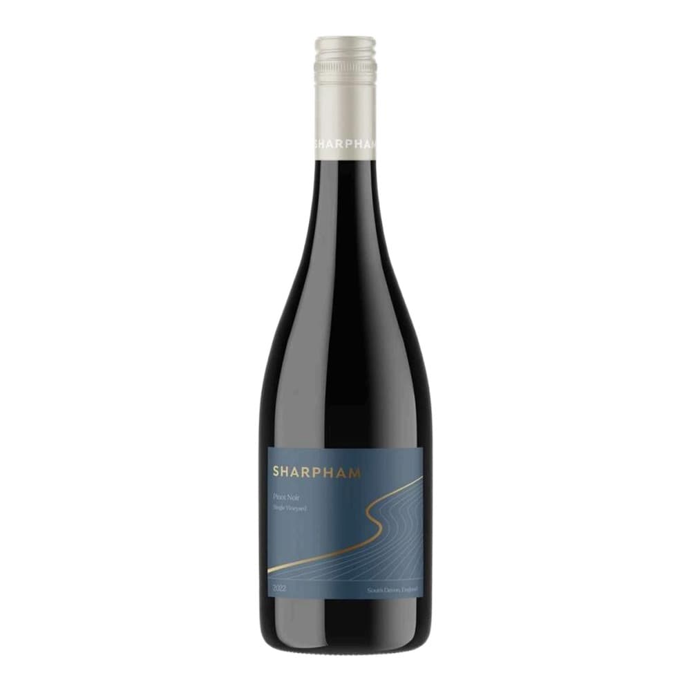 A bottle of Sharpham Pinot Noir single vineyard wine with a dark blue label featuring gold wavy design, isolated on a white background.