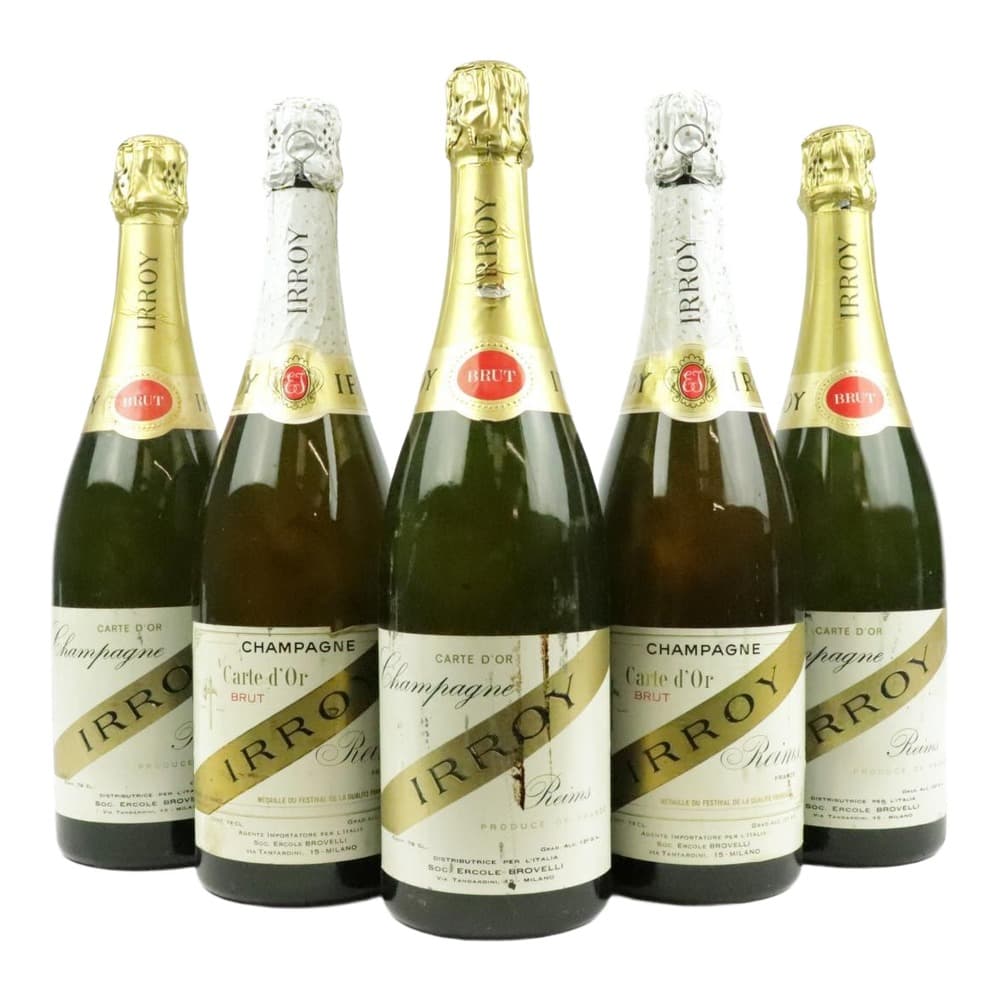 Five bottles of Irroy Carte d'Or Brut Champagne arranged on a white background, featuring gold foil capsules and labels.