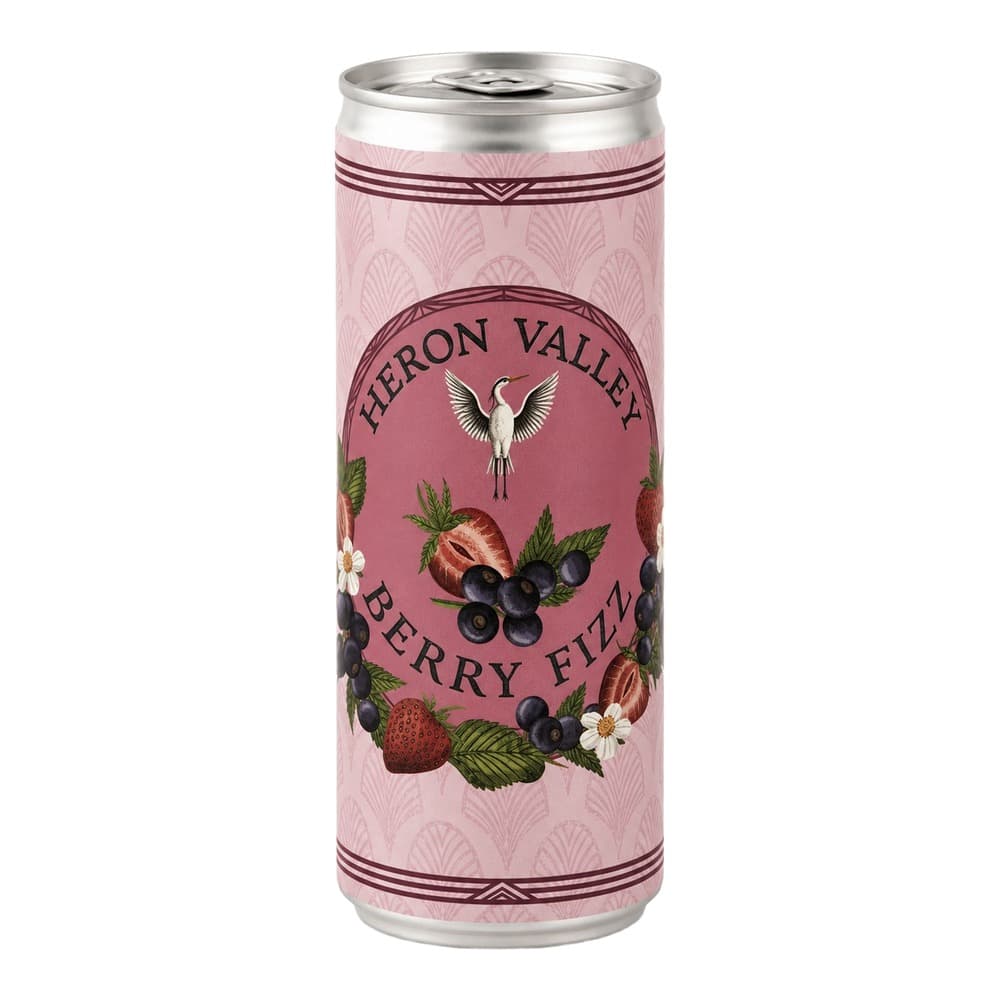 A tall aluminium can of Heron Valley Berry Fizz featuring a pink label with illustrations of strawberries, blackberries, white flowers, and a heron emblem against a pale pink patterned background.