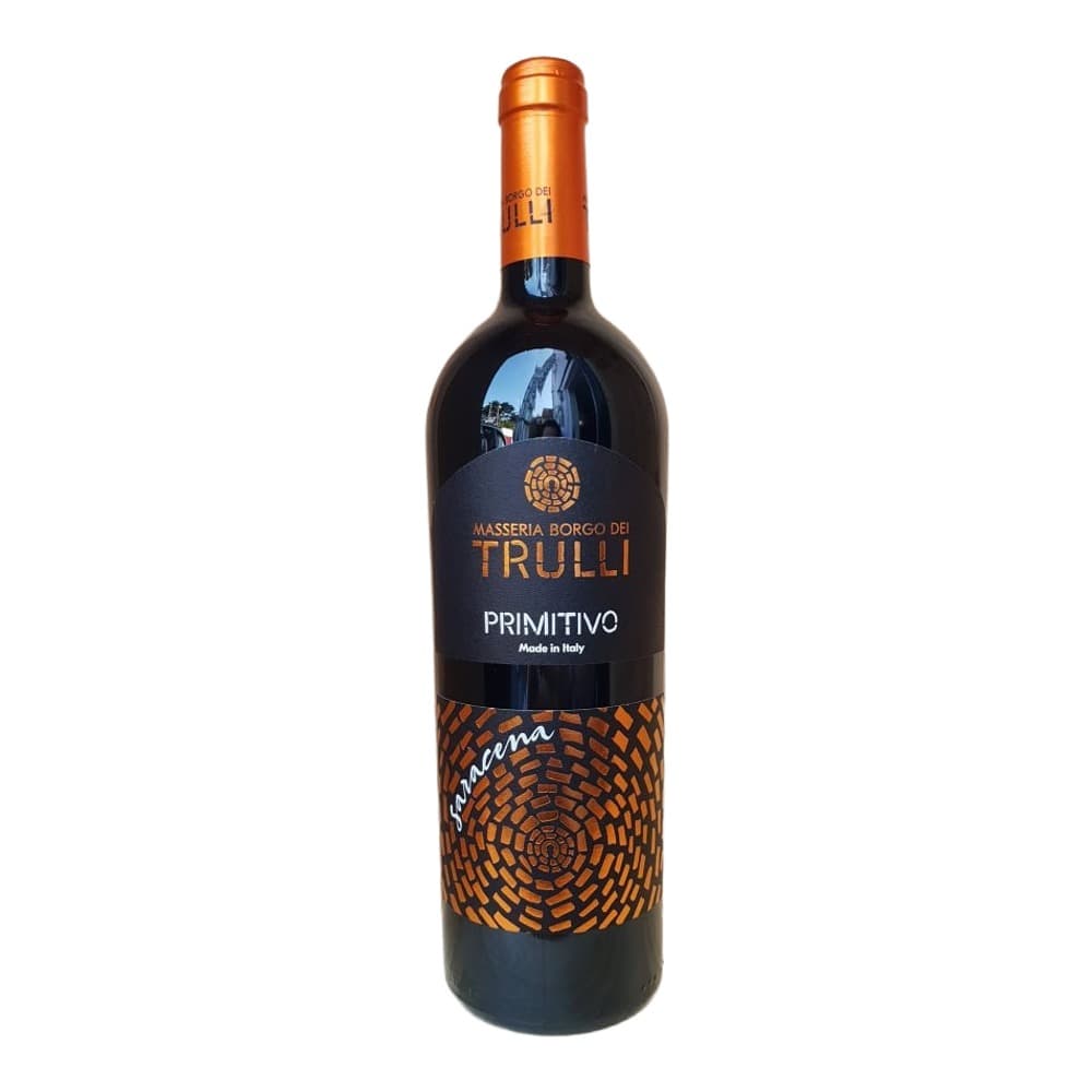 A bottle of Masseria Borgo dei Trulli Primitivo red wine with an orange foil cap and black label featuring an orange geometric pattern, displayed on a light wooden background.