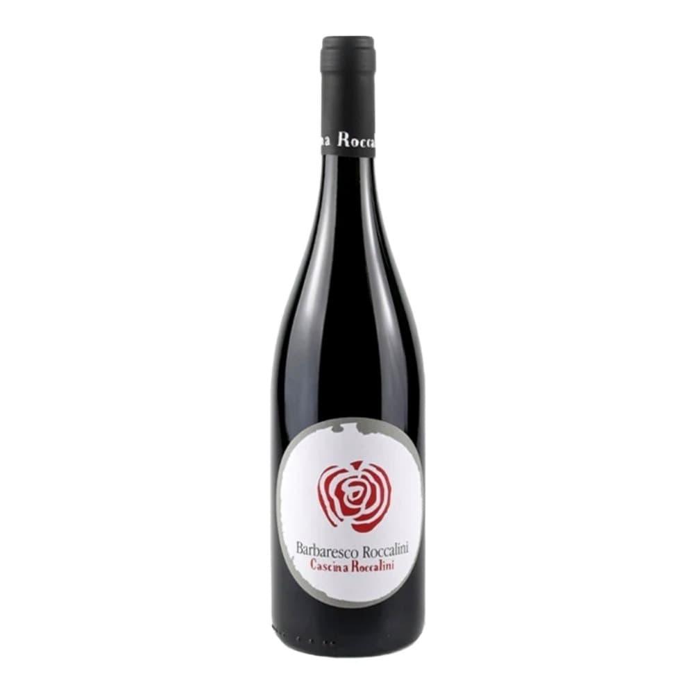 A bottle of Barbaresco Roccalini red wine with a white label featuring a red spiral rose design, photographed against a plain beige background.