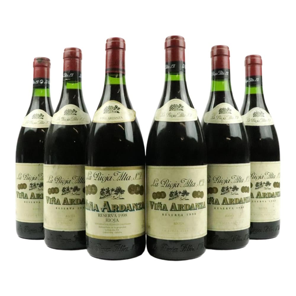 Six bottles of La Rioja Alta Viña Ardanza Reserva 1998 red wine arranged in a group against a white background, displaying burgundy foil caps and cream-coloured labels.