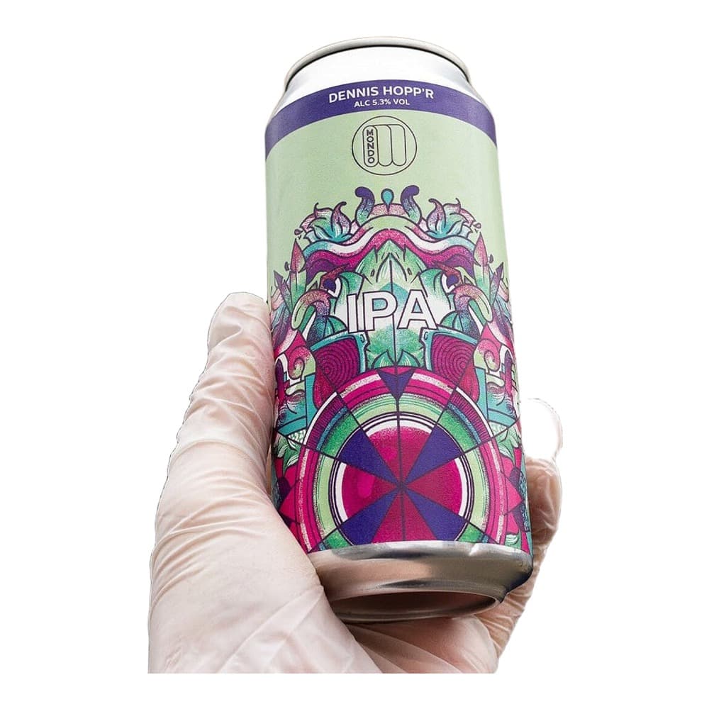 A hand wearing a white glove holding a colorful IPA beer can with vibrant purple, pink, and green artwork featuring ornate designs and geometric patterns