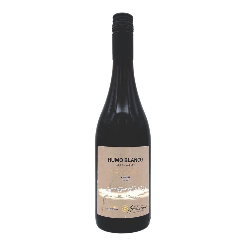 Bottle of Humo Blanco Syrah 2018 red wine from Lolol Valley, Chile, featuring a beige label with mountain landscape imagery on a dark glass bottle with black capsule.