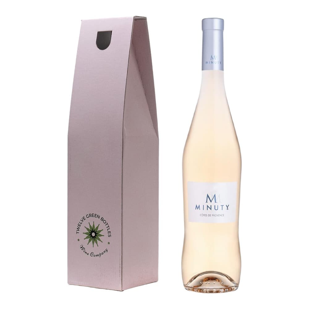 A bottle of M Minuty rosé wine from Côtes de Provence displayed next to its pale pink gift box from Travelve Green Bottles Wine Company.