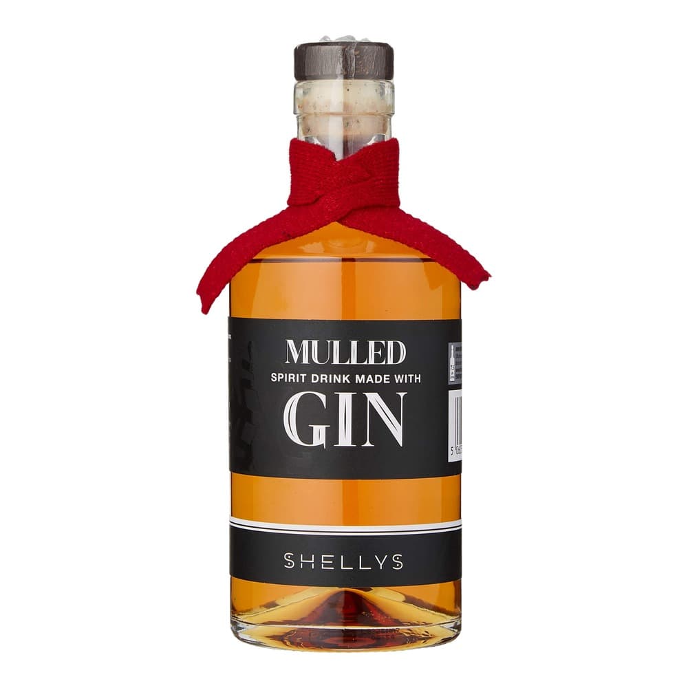 Bottle of Shellys mulled gin spirit drink with red knitted bow and dark wooden cap against white background
