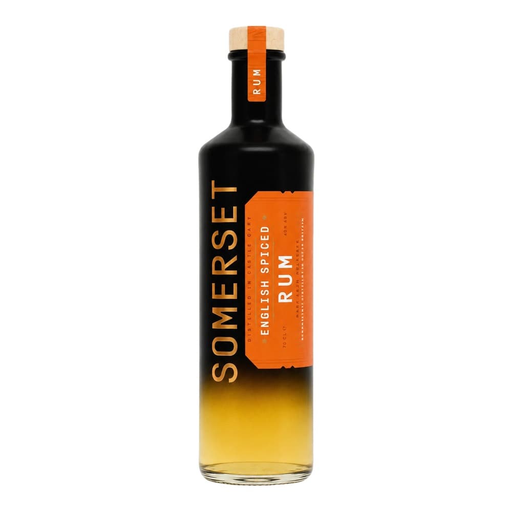 A bottle of Somerset English Spiced Rum with an orange label on a white background, featuring a natural cork stopper and visible golden-amber liquid inside.
