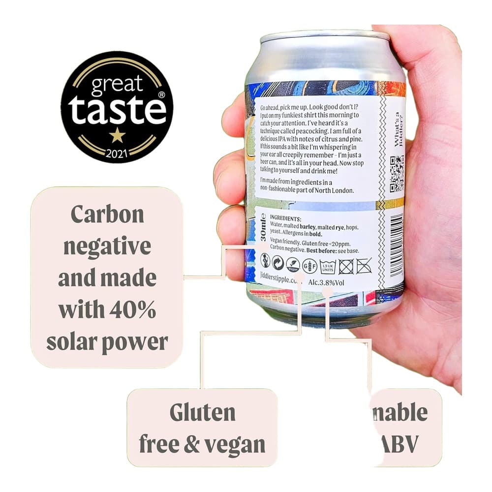 A person holding a Fiddler's Elbow IPA beer can against a blurred green garden background, displaying the Great Taste 2021 award and product information.