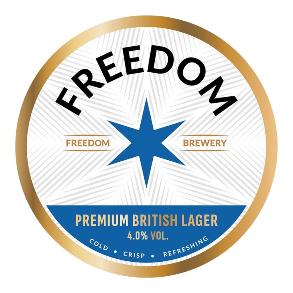 Circular beer label for Freedom Brewery Premium British Lager featuring a blue star emblem on white background with gold trim