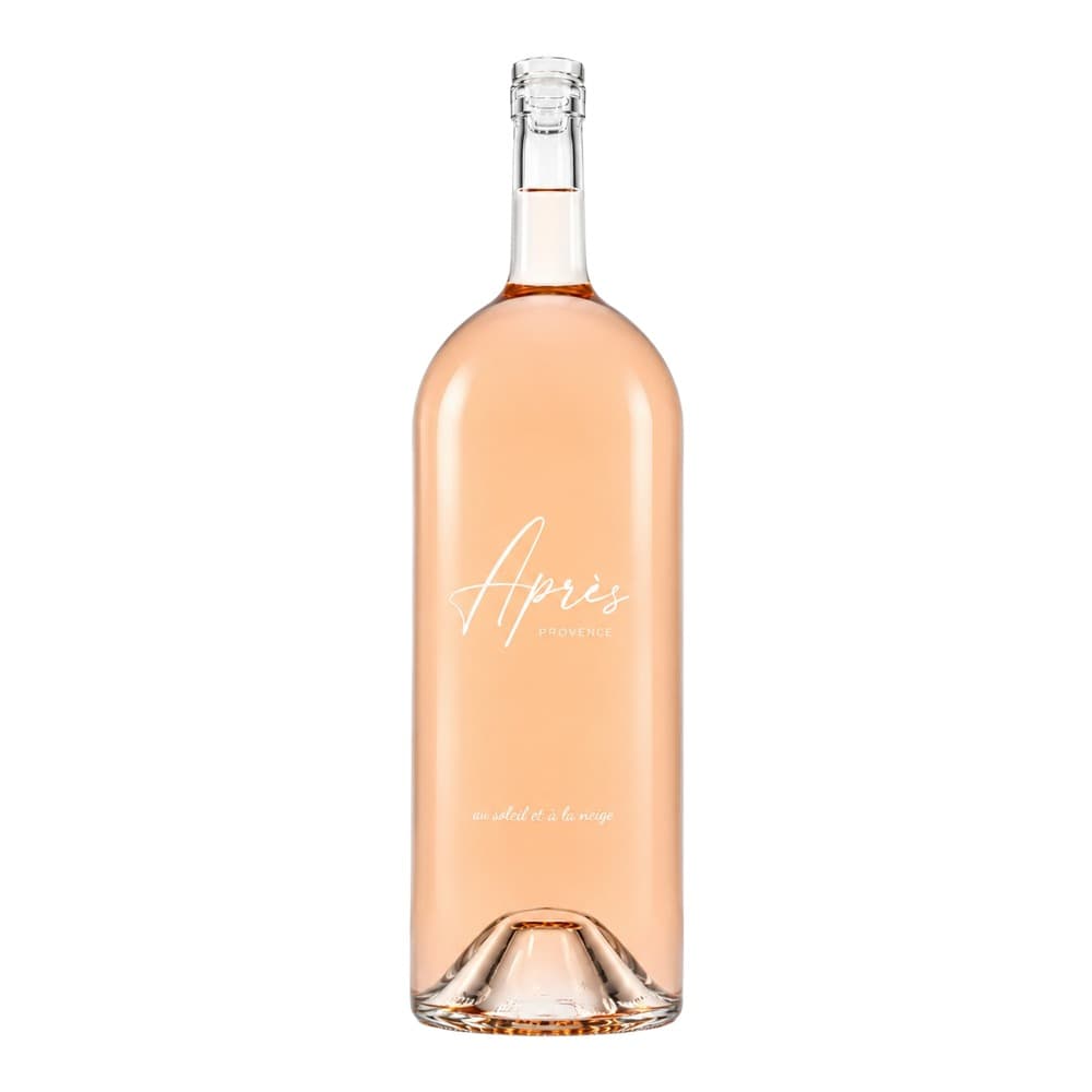 A bottle of Après Provence rosé wine with pale pink liquid against a white background, featuring cursive branding and French text on the label.