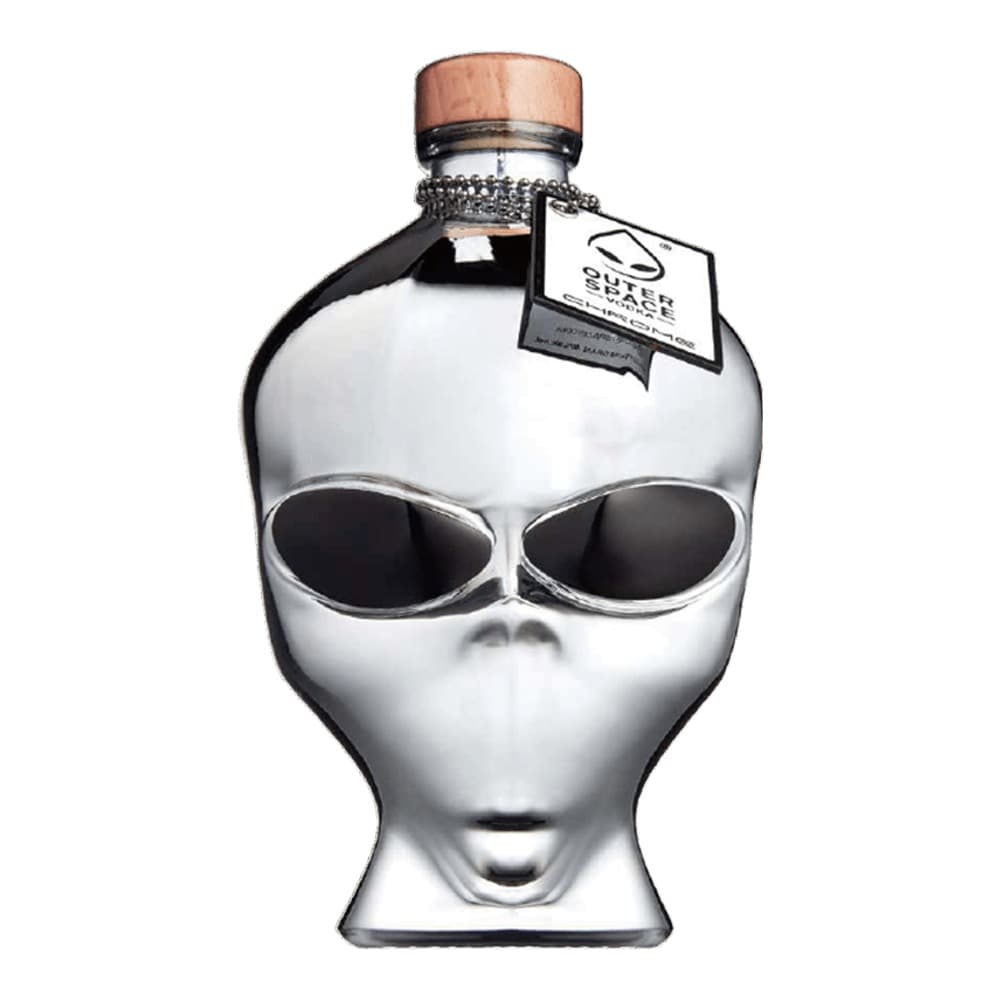 A novelty white spirit bottle shaped like an alien head with large oval black eyes, copper-coloured cap, and a hanging tag on a plain white background.