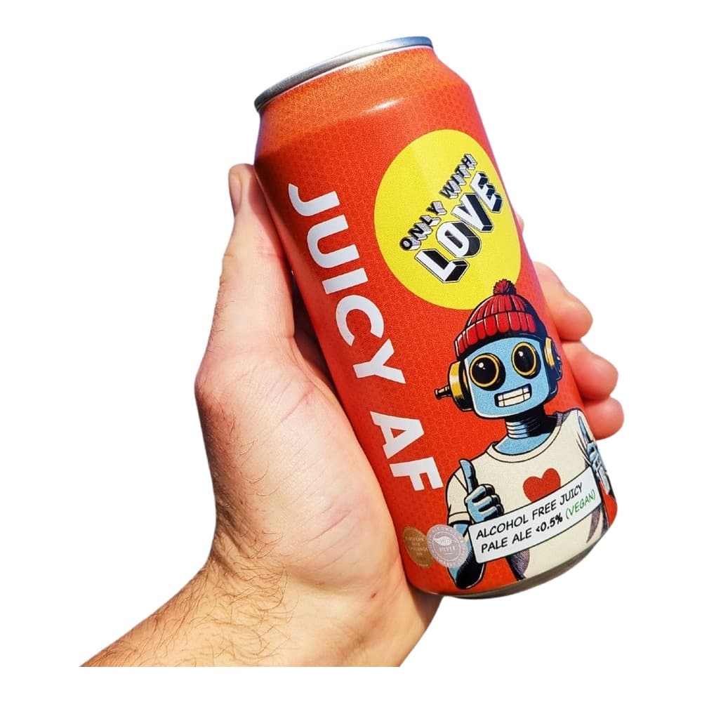 Hand holding a red can of Juicy AF alcohol-free pale ale with cartoon robot character design against white background