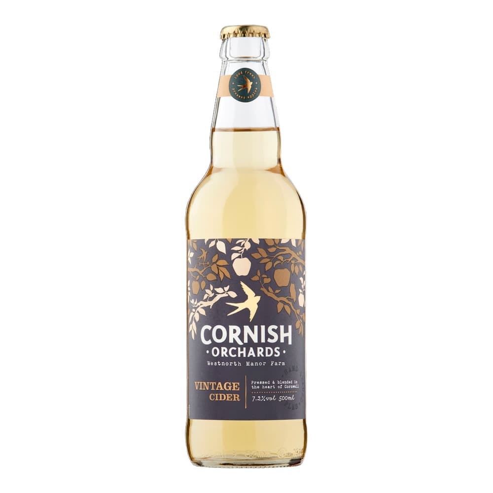 A bottle of Cornish Orchards Vintage Cider with pale golden liquid, featuring a dark label with gold foliage design and gold crown cap, photographed against a black background.