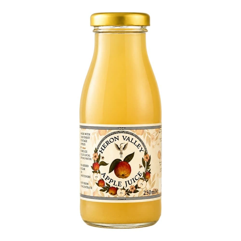 A 250ml glass bottle of Hebron Valley Apple Juice with a golden cap and decorative label featuring apples and botanical imagery on a white background.