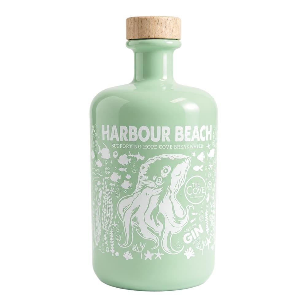 A pale green glass bottle of Harbour Beach premium gin with a wooden cork stopper, featuring white illustrated marine and coastal motifs on the label.