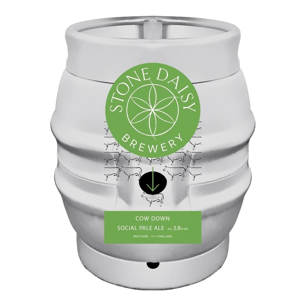 A white metal beer keg with a green circular logo for Stone Daisy Brewery featuring a geometric flower design, and a green label reading 'Cow Down Social Pale Ale' at 3.8% alcohol by volume, produced in Wiltshire, England.