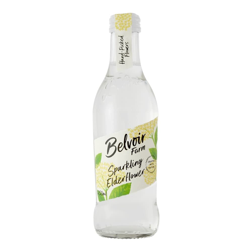 A clear glass bottle of Belvoir Farm Sparkling Elderflower drink on a white background, featuring a white label with yellow elderflower illustrations and green leaf accents.