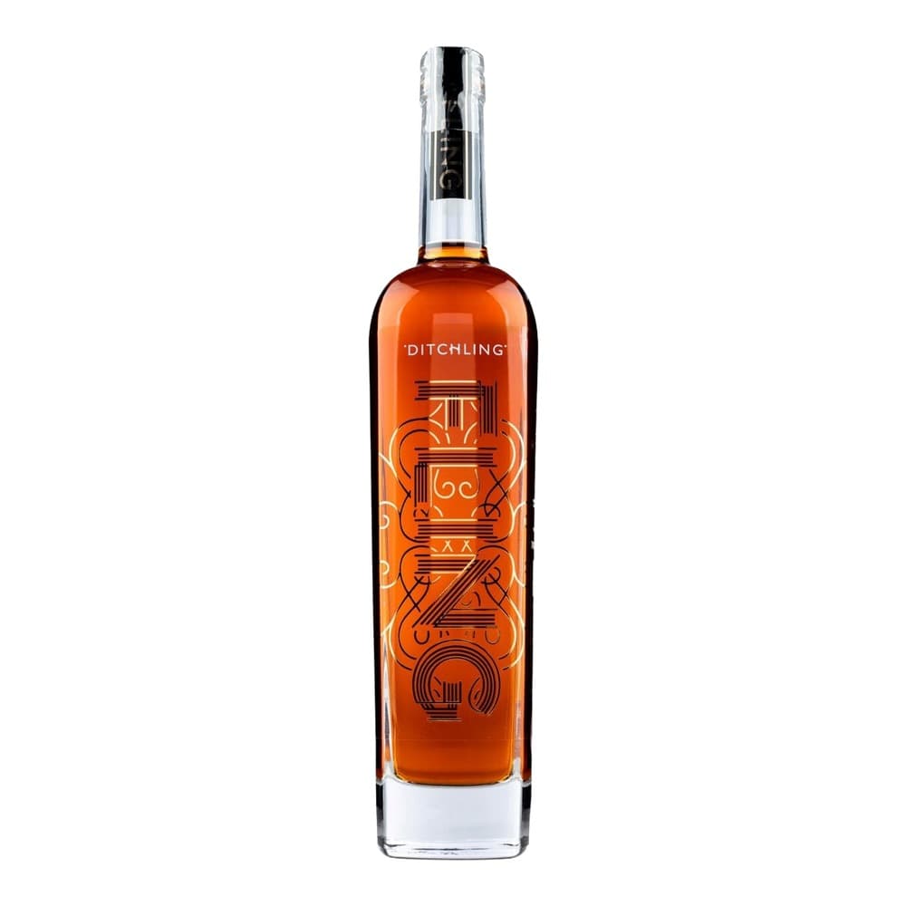 Amber coloured spirit bottle with orange ornamental label design, displayed on white background with three award medals shown to the right.