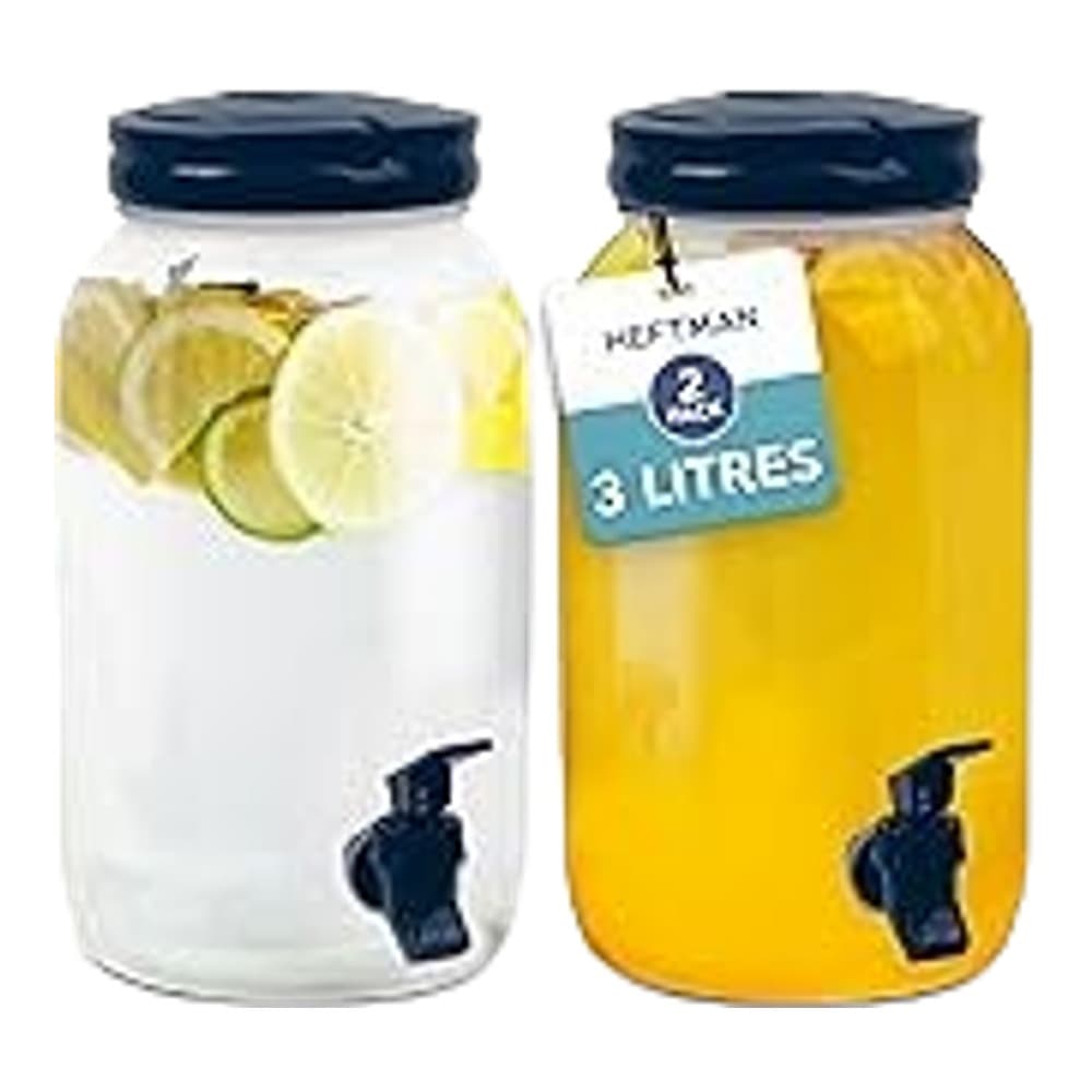 Two clear glass beverage dispensers with dark blue lids side by side, one containing lemon water and one containing orange juice, each with a tap at the base.