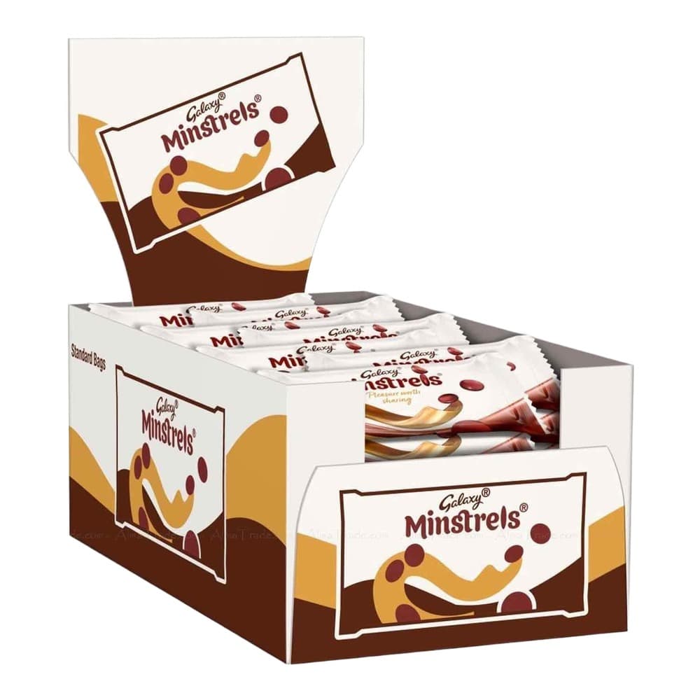 A cardboard display box of Galaxy Minstrels chocolate sweets showing multiple individual white packets with the product branding, featuring the distinctive logo with chocolate-covered caramel shapes.