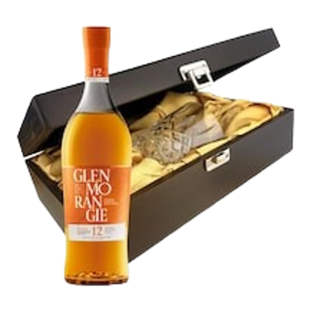 Bottle of Glen Grant whisky displayed next to an open black luxury gift box containing whisky glasses and accessories