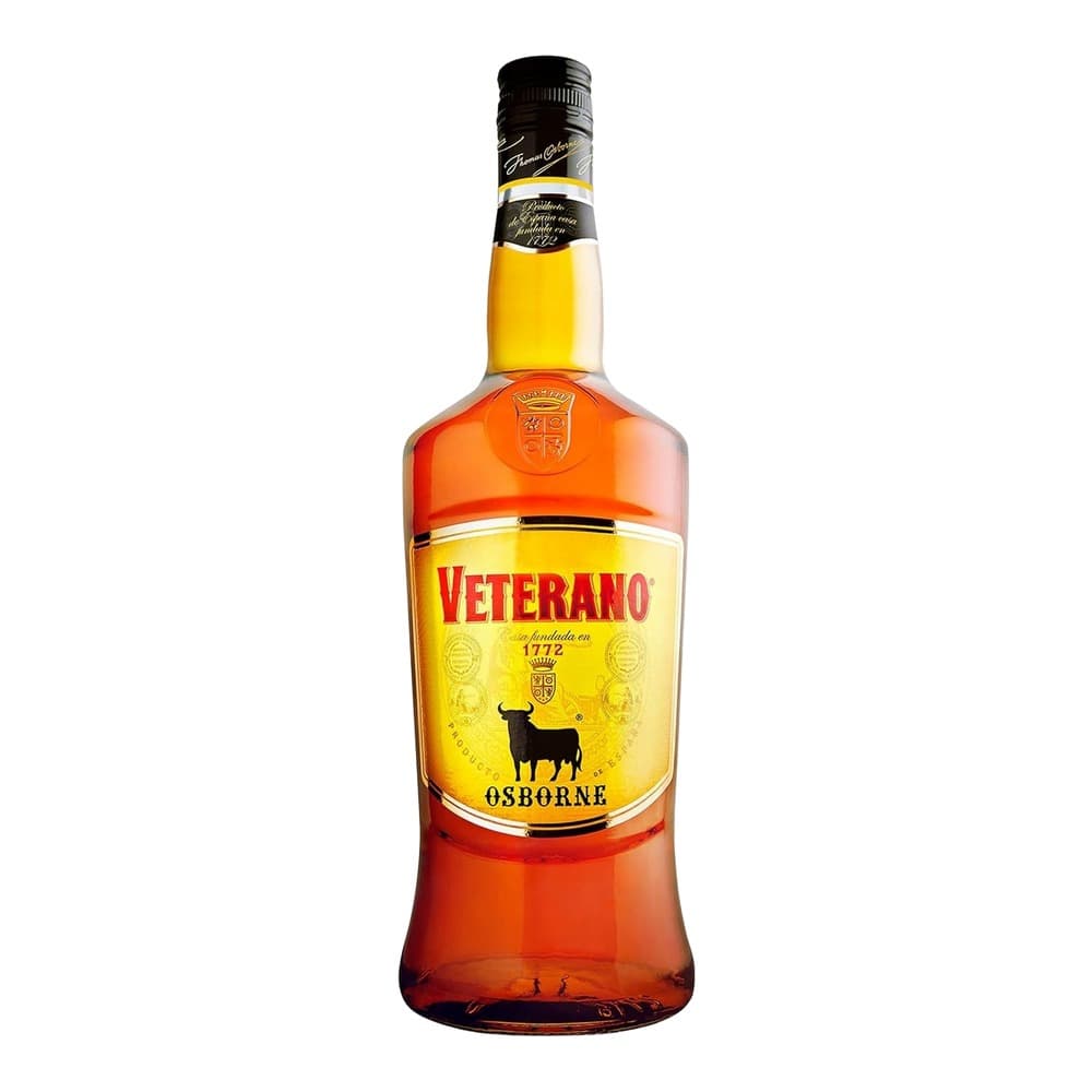 A bottle of Veterano brandy by Osborne with a golden yellow label and red liquid, isolated on a white background.