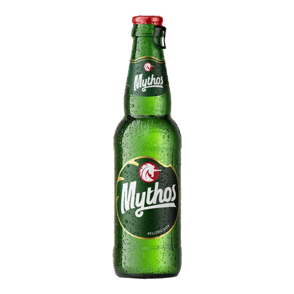 A chilled green glass bottle of Mythos Hellenic beer with condensation, featuring a red cap and branded label on a white background.