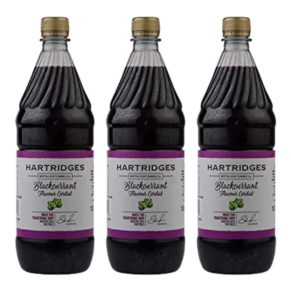 Three plastic bottles of Hartridges blackcurrant squash concentrate with purple labels and gold caps, displayed against a white background.