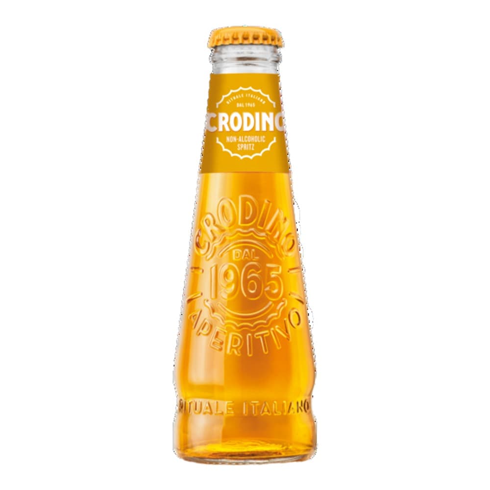 A glass bottle of Rodino non-alcoholic spirit with a golden yellow liquid, featuring a white label with decorative design and a yellow metal cap, isolated on a white background.