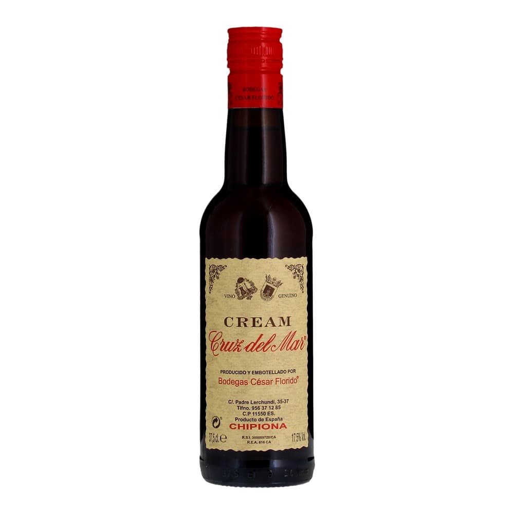 A bottle of Cruz del Mar Cream sherry wine with a red cap and cream-coloured label, isolated on a white background.