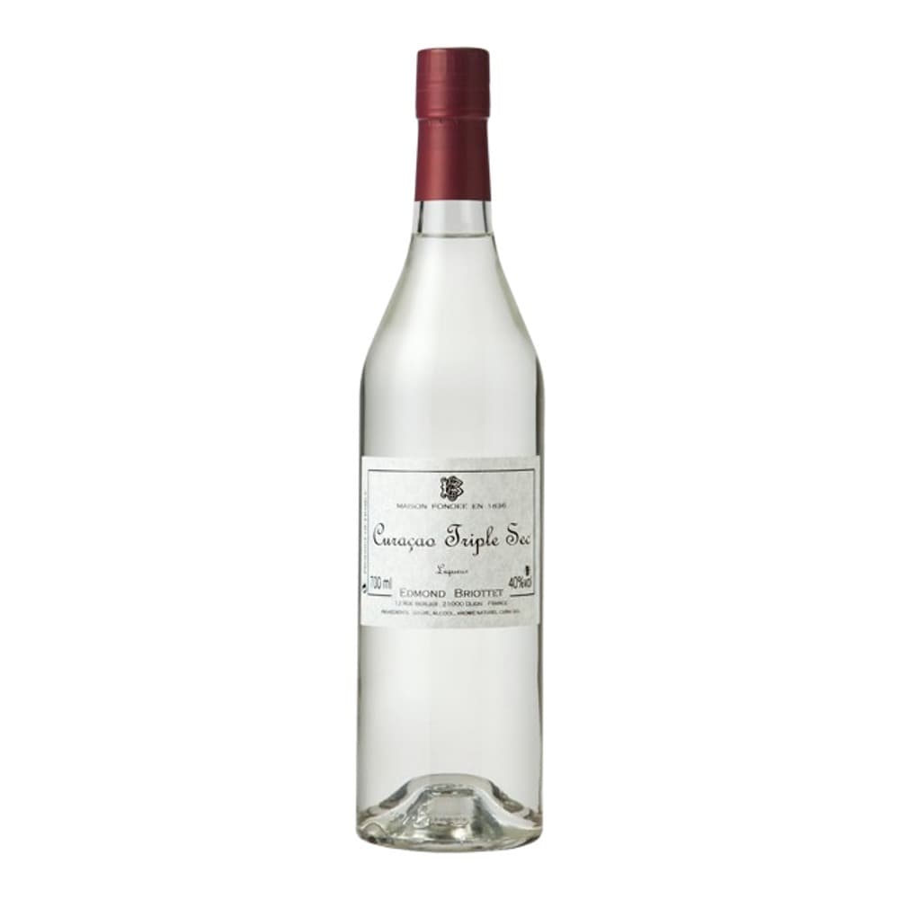 A clear spirit bottle with a burgundy cap and white label featuring cognac branding, photographed against a white background.