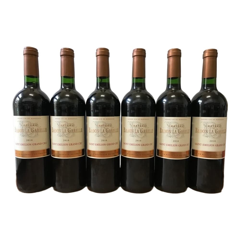 Six bottles of Château Badoin La Gardelle Saint-Emilion Grand Cru 2010 red wine arranged in a row against a neutral background.