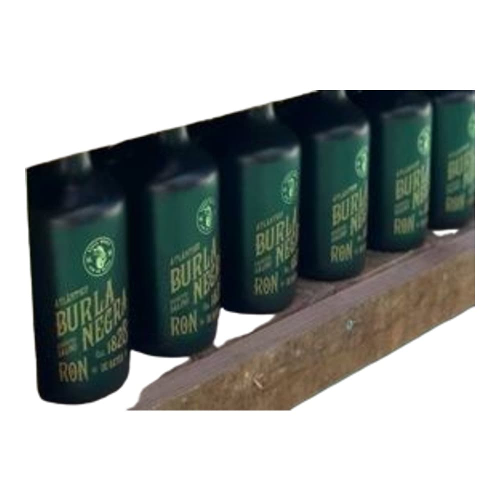 A row of six dark green Butter Rum bottles lined up on a rustic wooden shelf, showcasing the product in a display context.