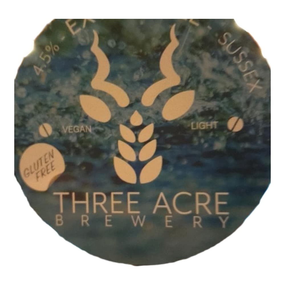 Close-up of a Three Acre Brewery beer bottle label featuring a stylised stag antler logo, with text indicating it is a vegan, gluten-free light beer at 4.5% ABV.