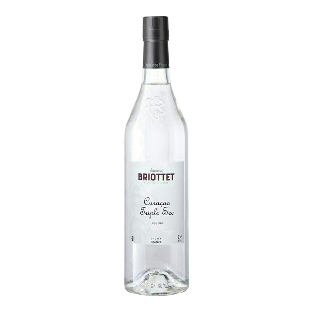 A clear glass bottle of Edmond Briottet Curaçao Triple Sec liqueur with a black cap, displayed against a plain white background.