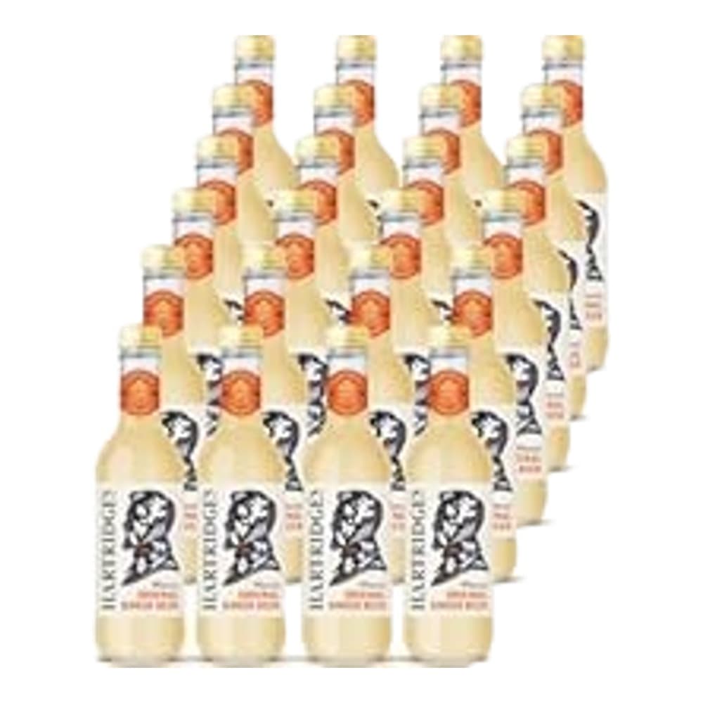 Multiple bottles of beverage arranged in rows against a plain white background, showing both peach/orange coloured bottles and white bottles with dark labels.